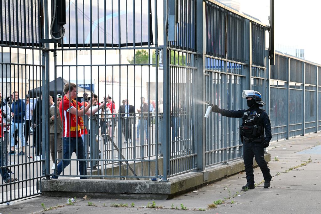 Police spray tear gas at Liverpool fans outside the stadium as fans struggle to enter prior to the UEFA Champions League final. Photograph: Matthias Hangst/Getty