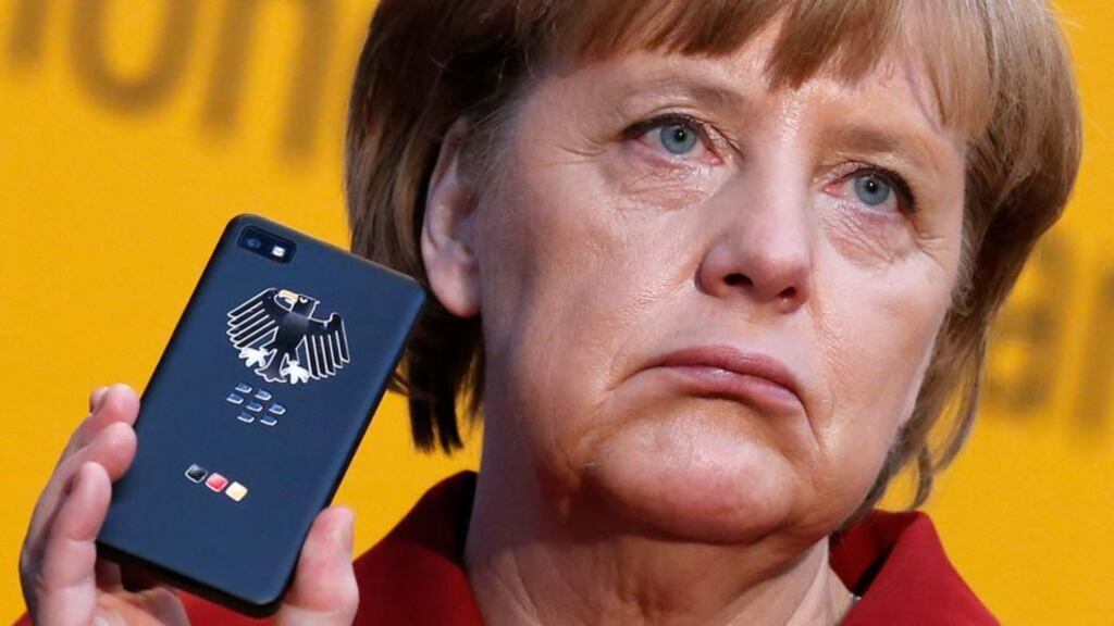 Angela Merkel holds a BlackBerry Z10 smartphone featuring high security  software, used for governmental communication, at a computer fair in Hanover in in March this year. Photograph: Reuters