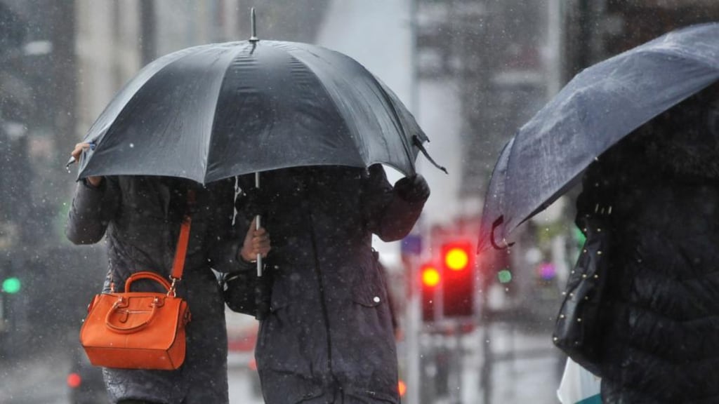 Pedestrians battle the wind and rain on Patrick’s Bridge in Cork during Wednesday’s storm. Photograph: Daragh Mc Sweeney/Provision