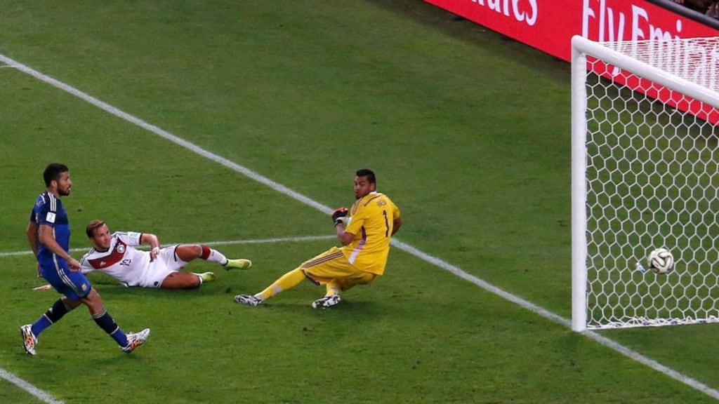 Germany’s Mario Götze scores the winner past Argentina goalkeeper Sergio Romero as  Ezequiel Garay looks on at the Maracana in Rio de Janeiro. Photograph: David Gray / Reuters