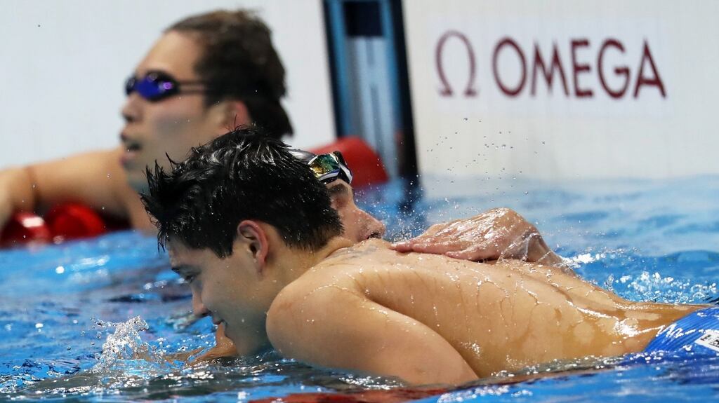 Second placed Michael Phelps of USA congratulates winner Joseph Schooling of Singapore after the men’s 100m butterfly final race. Photograph: EPA