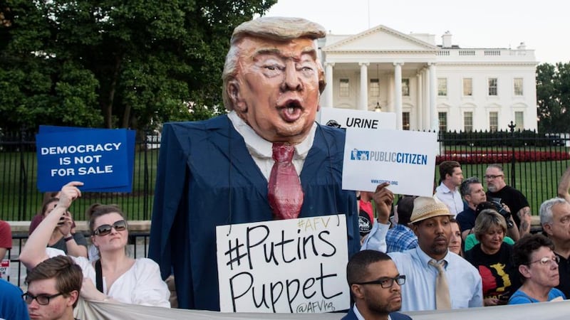 Putin’s puppet?: protesters outside the White House at a vigil to “demand democracy” and “confront corruption” after Donald Trump’s summit with the Russian president. Photograph: Michael Reynolds/EPA