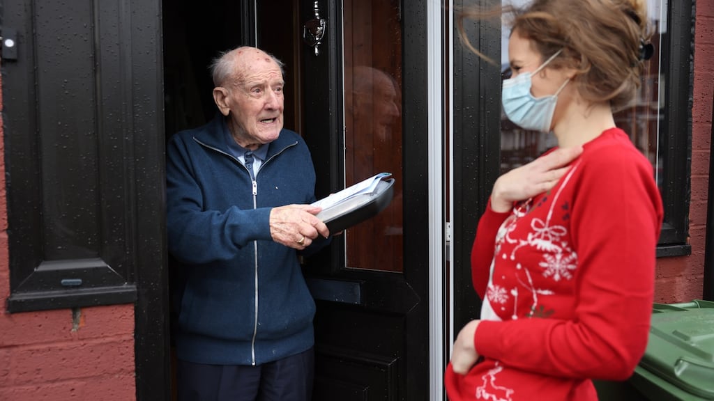 Friends of the Elderly volunteer Caroline Schroeder chats with Gerry Murphy, after delivering a hot Christmas meal to him in Dublin. Photograph: Dara Mac Dónaill/The Irish Times