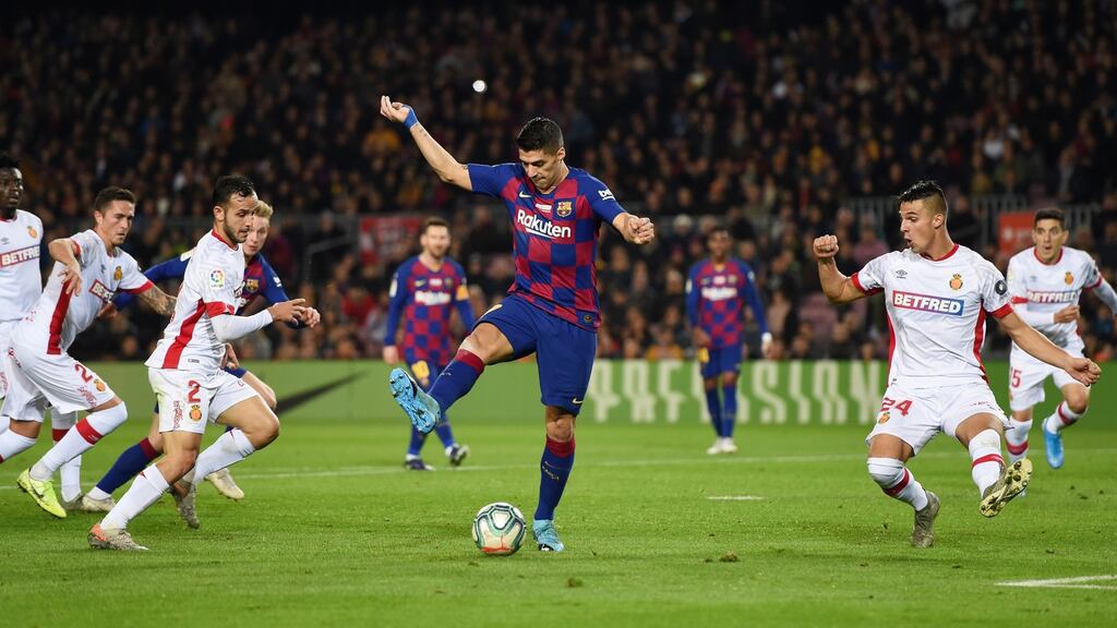 Luis Suarez scores Barcelona’s fourth goal with a backheel during the La Liga match against Mallorca at the Nou Camp. Photograph: Alex Caparros/Getty Image