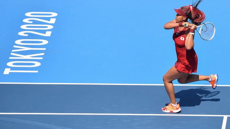 Japan’s Naomi Osaka returns a shot to China’s Zheng Saisai. Photo: Tiziana Fabi/AFP via Getty Images