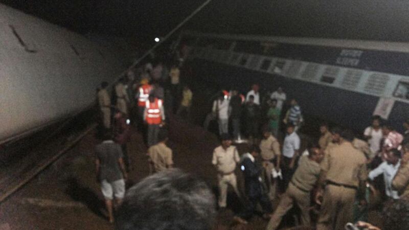 Police and members of the rescue operation stand at the site of a train derailment near Harda, Madhya Pradesh. Photograph: Reuters