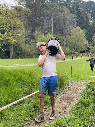 Conor Capplis enduring the weight of a heavy bucket at Spartan London West. Photograph: Sierra Lindman Marshall