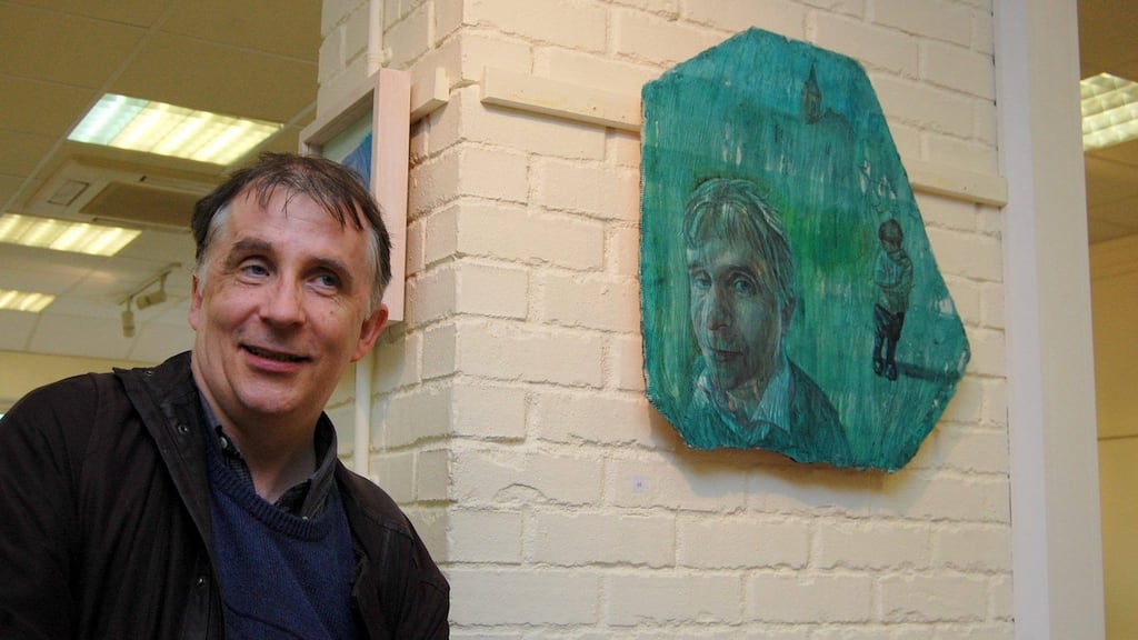 Kevin Higgins with his portrait by Christopher Banahan