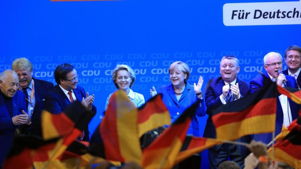 Angela Merkel, Germany’s chancellor and party leader of the Christian Democratic Union (CDU), center, stands with supporters on stage during victory celebrations after the German federal elections results were announced in Berlin, yesterday. Recent data shows that the German economy is likely to grow by about 0.4 per cent in the third quarter. Photographer: Krisztian Bocsi/Bloomberg