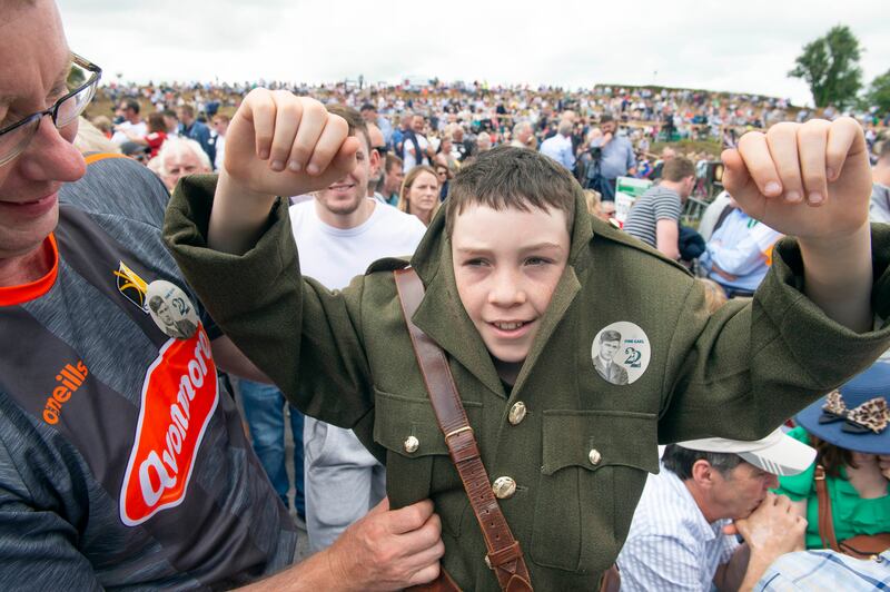 Padraig Healy from Castlecomer, Co Kilkenny gets some help putting on his Michael Collins uniform. Photograph: Michael Mac Sweeney/ Provision