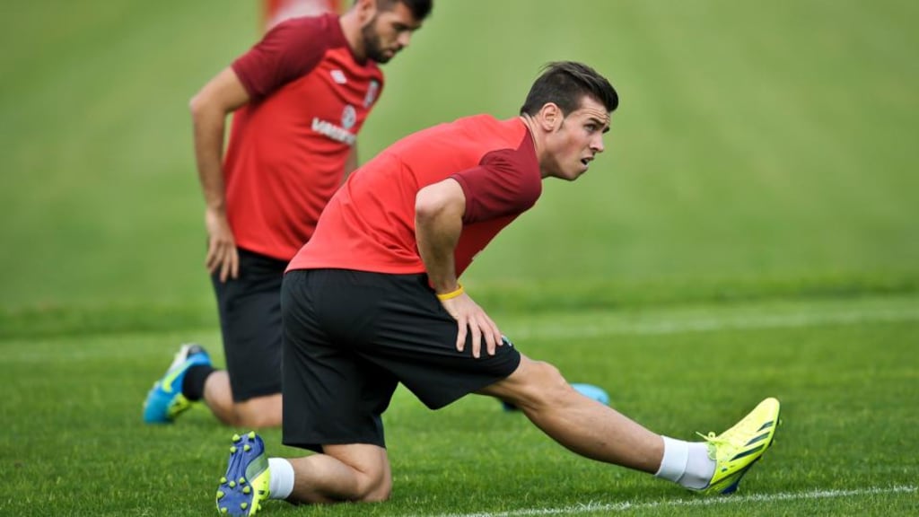 Gareth Bale stretches out on the pitch as he joins the Wales football team during a training session at The Vale Resort, Hensol. Photograph: Ben Birchall/PA Wire