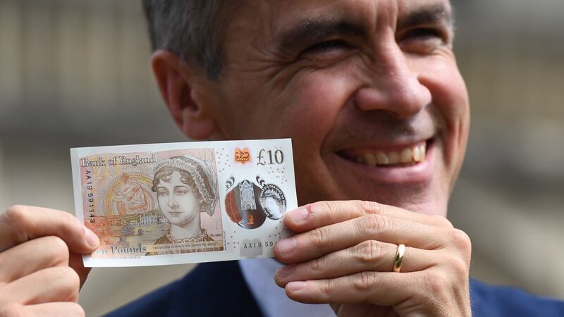 Mark Carney of the Bank of England with the new £10 note featuring Jane Austen. Photograph: Chris J Ratcliffe/Getty
