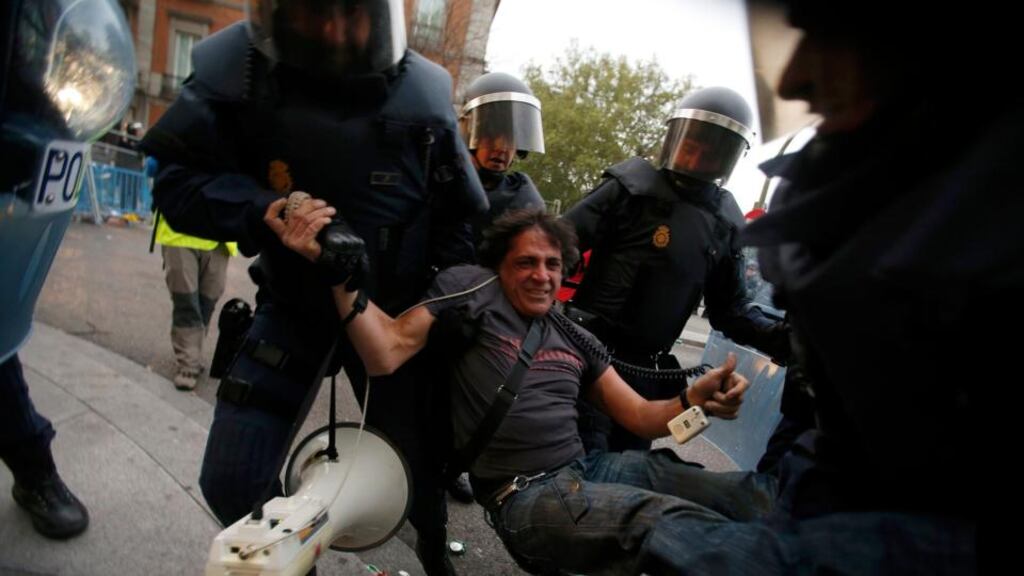 A protester is detained by Spanish riot police during a planned demonstration against the government in Madrid. Photograph: Sergio Perez/Reuters