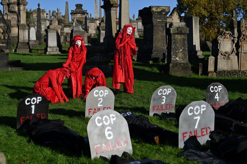 Performers from the Red Rebels conduct a funeral ceremony at Glasgow Necropolis to symbolise the failure of the Cop26 process, at Glasgow Cathedral on November 13th. Photograph: Paul Ellis/AFP via Getty