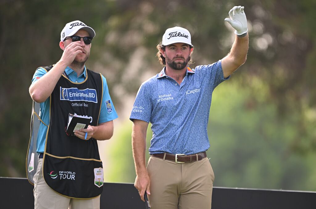 Cameron Young of the USA talks with his caddie Paul McBride on the 16th tee. Photograph: Ross Kinnaird/Getty