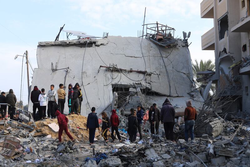 Palestinians look at the destruction after an Israeli strike on a residential building in Rafah. Photograph: Hatem Ali/AP