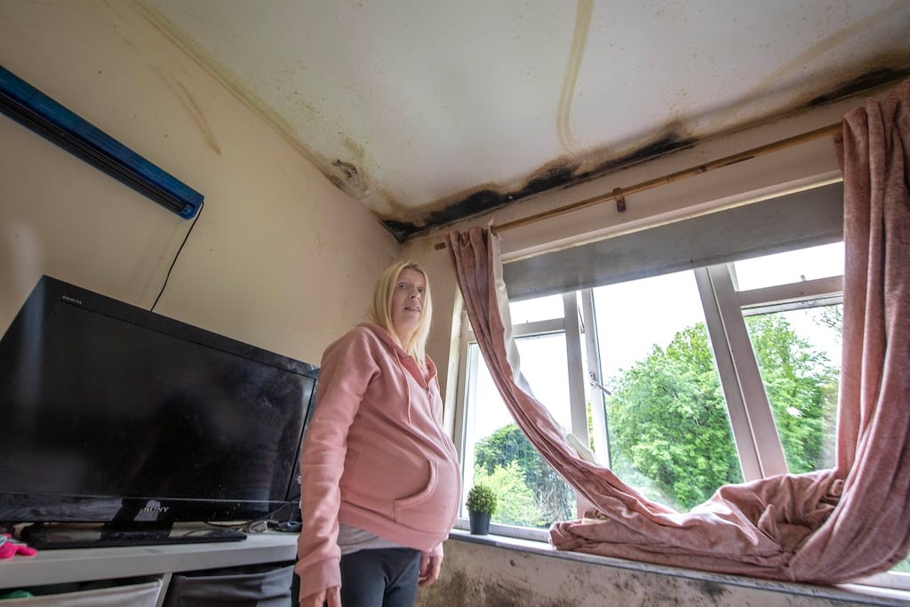 Sarah Williams beside the black mould growing in the bedroom of her house in Cobh. Photograph: Michael Mac Sweeney/Provision