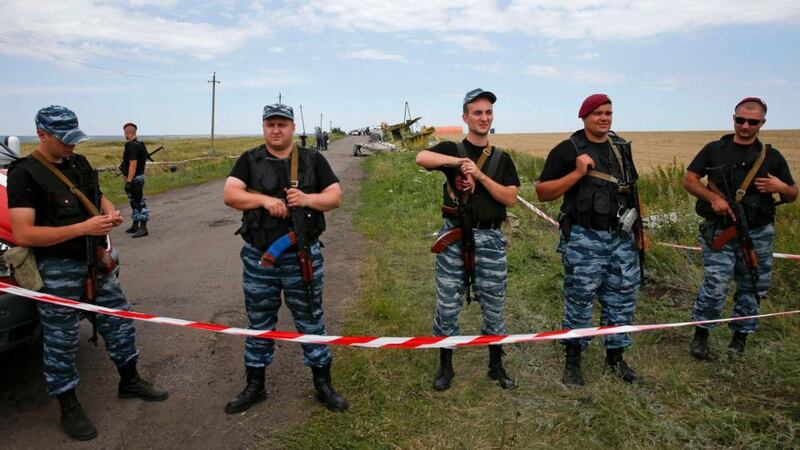 Armed pro-Russian separatists stand guard at a crash site of Malaysia Airlines Flight MH17, near the village of Hrabove in the Donetsk region today. Photograph: Maxim Zmeyev/Reuters.