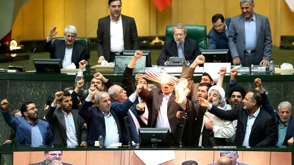 Iranian MPs burn a US flag in the parliament in Tehran following  US president Donald Trump’s decision to withdraw from the nuclear accord. Photograph: AFP