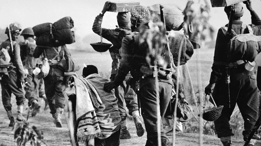 1971: An elderly Pakistani refugee is pushed aside by Indian troops advancing into the East Pakistan (Bangladesh) area during the Indo-Pakistani war. Photograph: Central Press/Getty Images