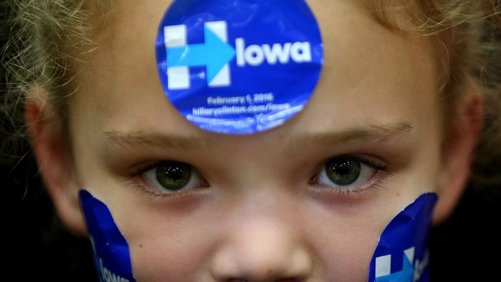 A young supporter wears campaign stickers on her face as Democratic presidential candidate Hillary Clinton speaks during a ‘get out to caucus’ event at Washington High School on January 30th in Cedar Rapids, Iowa. Photograph: Justin Sullivan/Getty Images