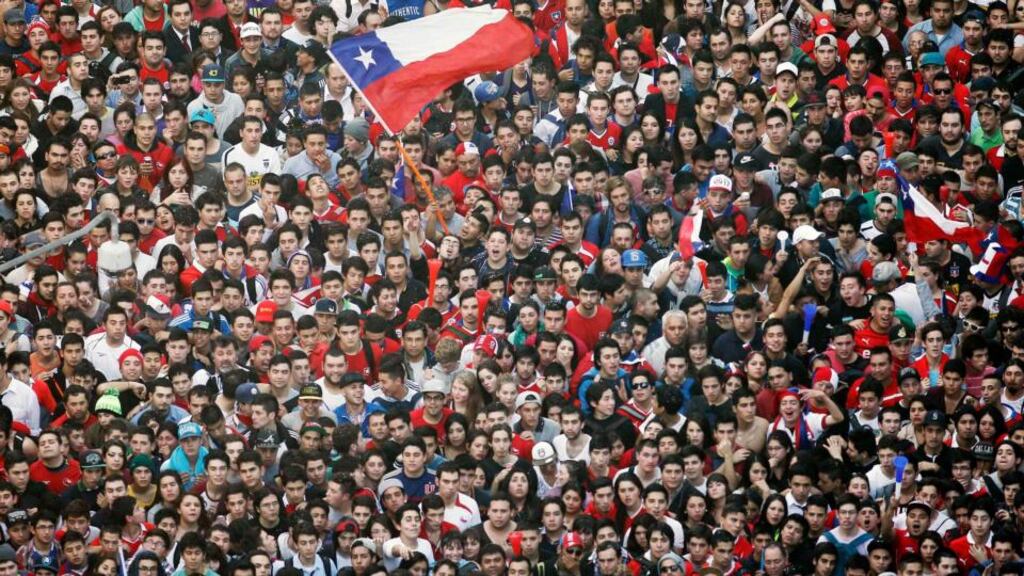 Chile fans celebrate victory over Spain at a public screening in Santiago. Photograph: Eliseo Fernandez/Reuters