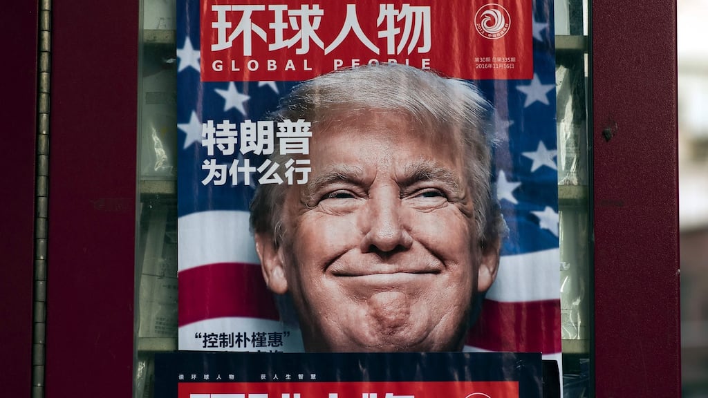 An advertisement for a magazine featuring US President-elect Donald Trump on the cover at a news stand in Shanghai. Photograph: Johannes Eisele/Getty Images