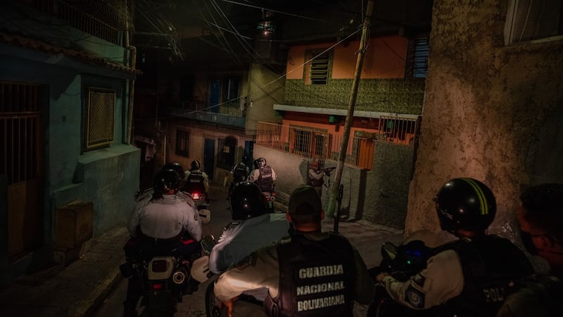 National guard officers raid a house in Caracas where people had broken lockdown rules by having a gathering. Photograph: Adriana Loureiro Fernandez/The New York Times
