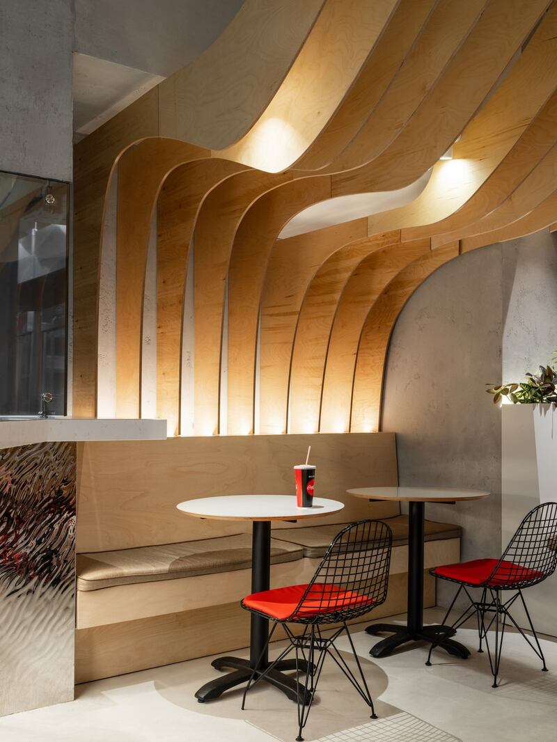 Greta Project delivered a different sort of undulating ceiling using plywood waves in its look for Chicken Mafia, a restaurant in Moscow.