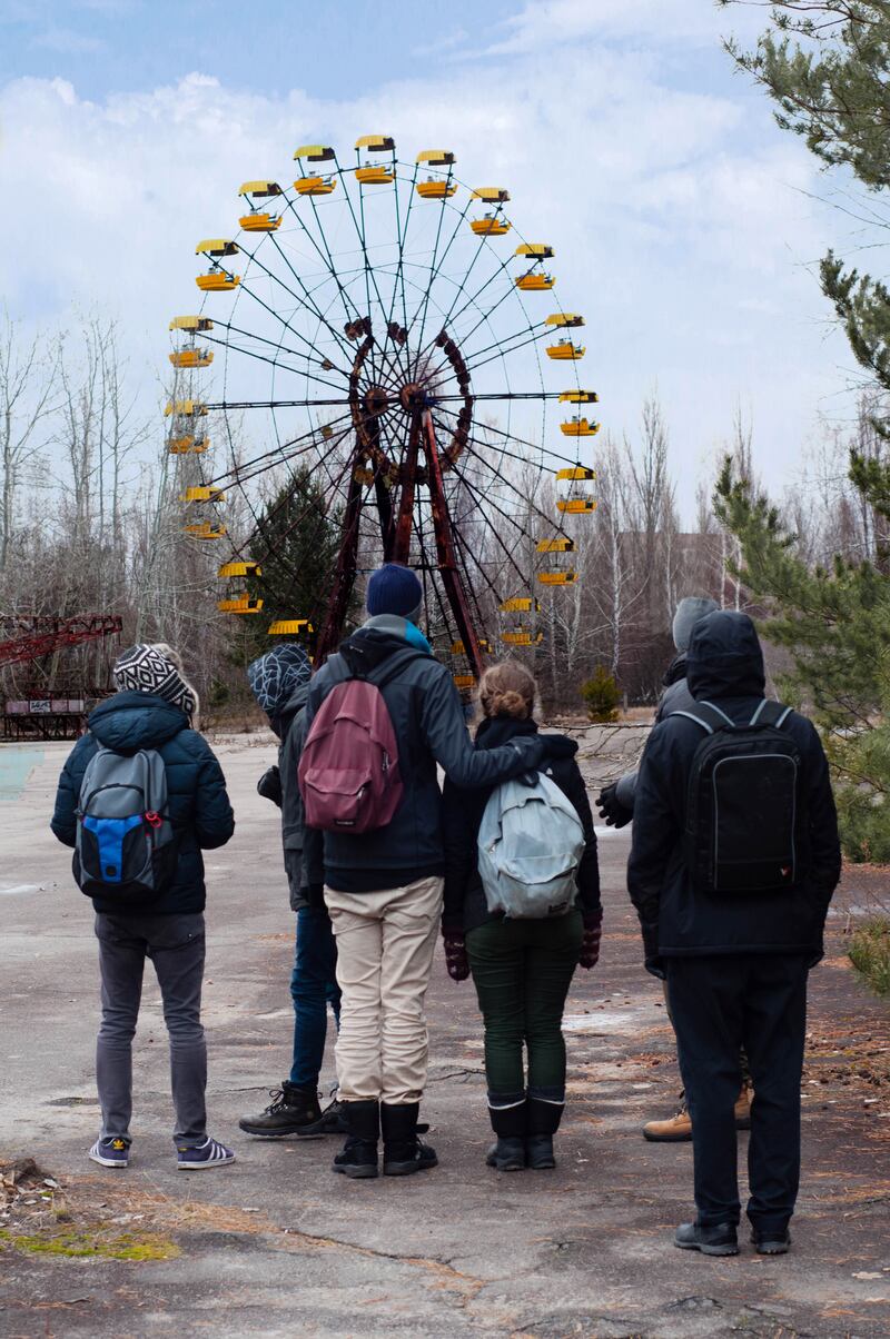Group of tourists in front of the Ferris wheel in Pripyat, near Chernobyl’s nuclear power plant. Photograph: iStock/Getty Images