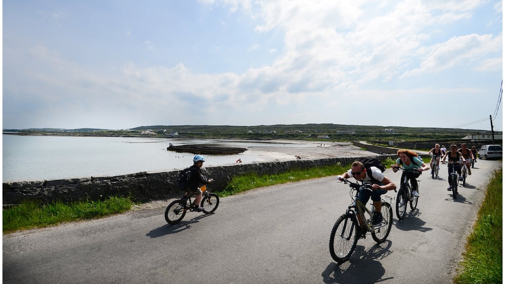 Cyclists on Inis Mór, the largest of the Aran Islands. Numbers flying to the islands last year increased by 2.5 per cent, from to 39,506. Photograph: Bryan O’Brien.