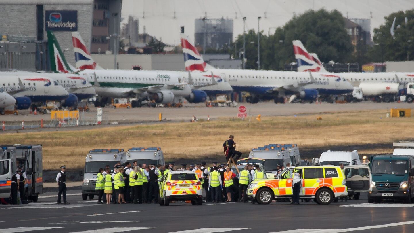 Emergency services surround protestors from the  Black Lives Matter movement after they locked themselves to a tripod on the runway at London City Airport. Photograph: Getty
