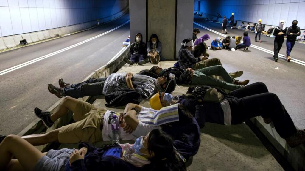 Pro-democracy protesters sleep at a tunnel blocked by protesters near the office of the Chief Executive in Hong Kong. Photograph: Reuters