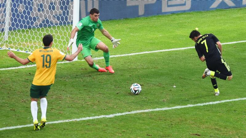 David Villa flicks the ball past Australian goalkeeper Mathew Ryan. Photograph: David Ramos/Getty Images