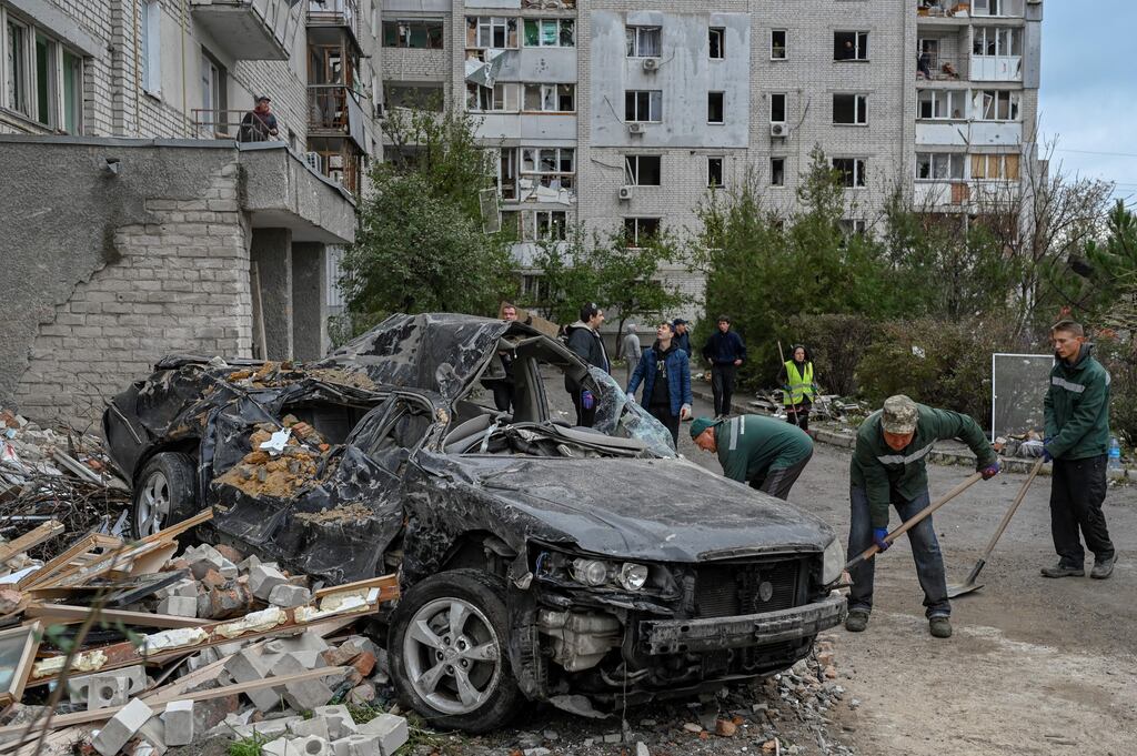 People clean the area after a rocket attack in Mykolaiv on Sunday. Photograph: Bulent Kilic/AFP/Getty