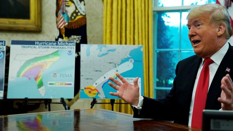 US President Donald Trump talks about Hurricane Michael next to maps and projections on the storm during a meeting in the Oval Office at the White House in Washington on Wednesday. Photograph: Jonathan Ernst/Reuters