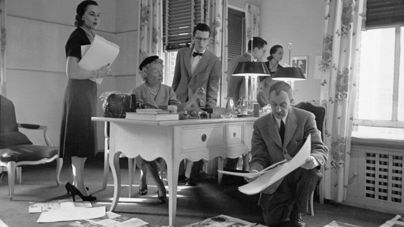Irish-born magazine editor Carmel Snow (nee White, 1887-1961) of Harper’s Bazaar (second left) sits behind a desk and looks over the magazine’s layout with photographer Alexey Brodovitch in New York, December 1952. Photograph: Walter Sanders/The LIFE Picture Collection/Getty Images