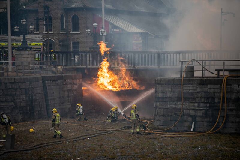 Dublin Fire Brigade members battle a blaze near the IFSC. Photograph: Damien Storan