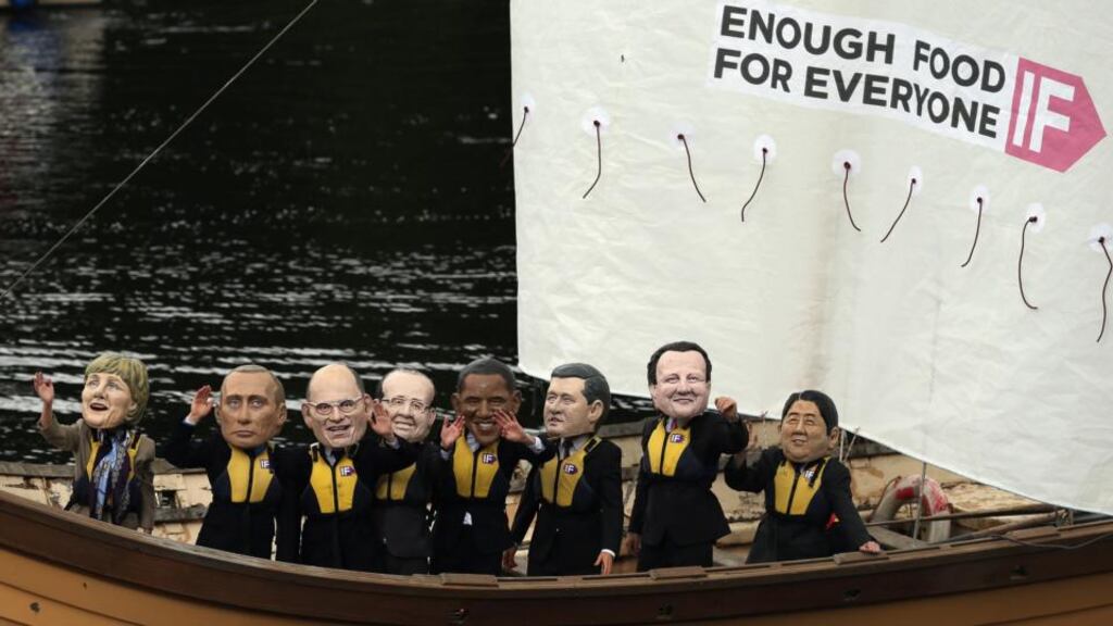 Protesters from the  Enough Food For Everyone IF coalition, wearing  giant G8 leaders’ heads, sail in a Viking-style boat close to the Kellyhevlin Hotel, close to the G8 venue of Lough Erne, in Enniskillen. Photograph: Matt Cardy/Getty Images