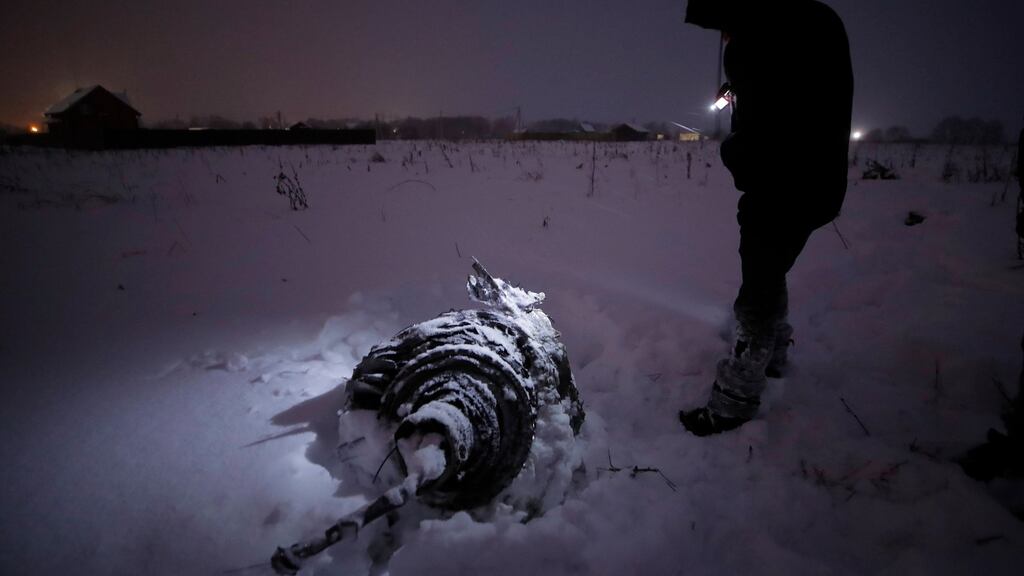 A man stands near a part of a Saratov Airlines Antonov AN-148 flight that crashed after taking off from Moscow’s Domodedovo airport, outside Moscow, Russia, on Sunday. Photograph: Maxim Shemetov/Reuters