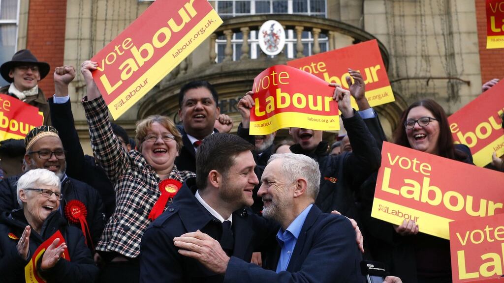 Labour Party leader Jeremy Corbyn embraces newly elected member of parliament for Oldham West and Royton, Jim McMahon. The byelection was triggered by the death of Labour Party MP Michael Meacher. Photograph: AFP/Getty Images