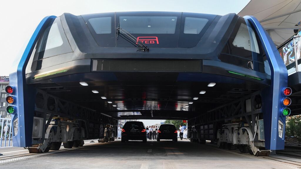 China’s Transit Elevated Bus: The blue, tunnel-like vehicle can carry up to 300 passengers in one carriage. Photograph: Luo Xiaoguang/Xinhua/AP