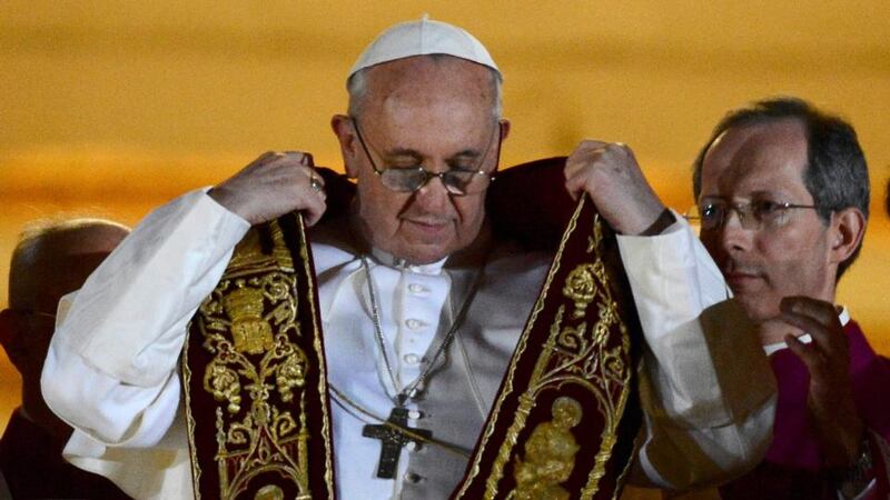 Newly elected Pope Francis, Cardinal Jorge Mario Bergoglio of Argentina, appears on the balcony of St Peter's Basilica after being elected by the conclave of cardinals, at the Vatica this evening.