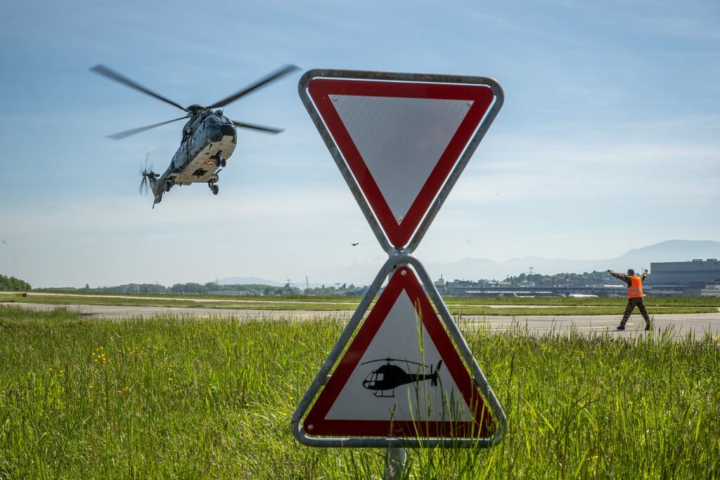 A Swiss Air Force helicopter lands at Geneva Airport during a military drill in Geneva. Photograph: Fabrice Coffrini/AFP via Getty Images