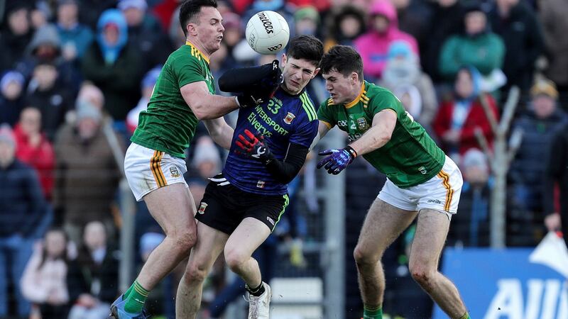 Mayo’s Conor Loftus is tackled by James McEntee and Ethan Devine of Meath. Photograph: Laszlo Geczo/Inpho