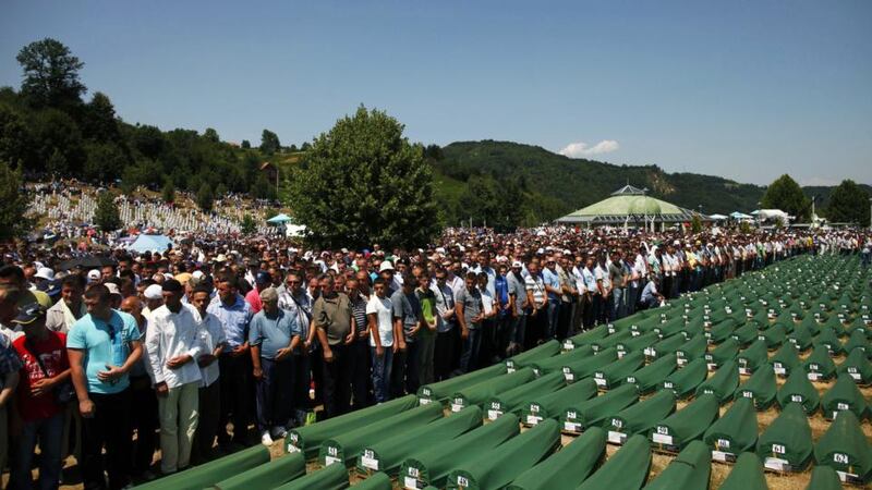A file image of Bosnian Muslims praying near coffins at a Memorial Centre in Potocari  during a mass burial of more than 520 victims of the  Srebrenica massacre. Photograph: Dado Ruvic/Reuters.