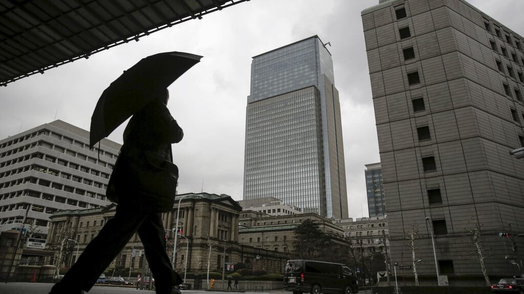A businessman walks near the Bank of Japan (BOJ) headquarters in Tokyo
