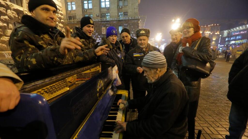 A pro-EU activist plays a piano in a street near a rally in Independence Square in Kiev yesterday. Photograph: AP Photo/Dmitry Lovetsky