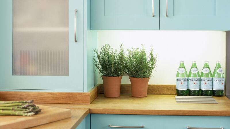 Turquoise painted kitchen units and cupboards.