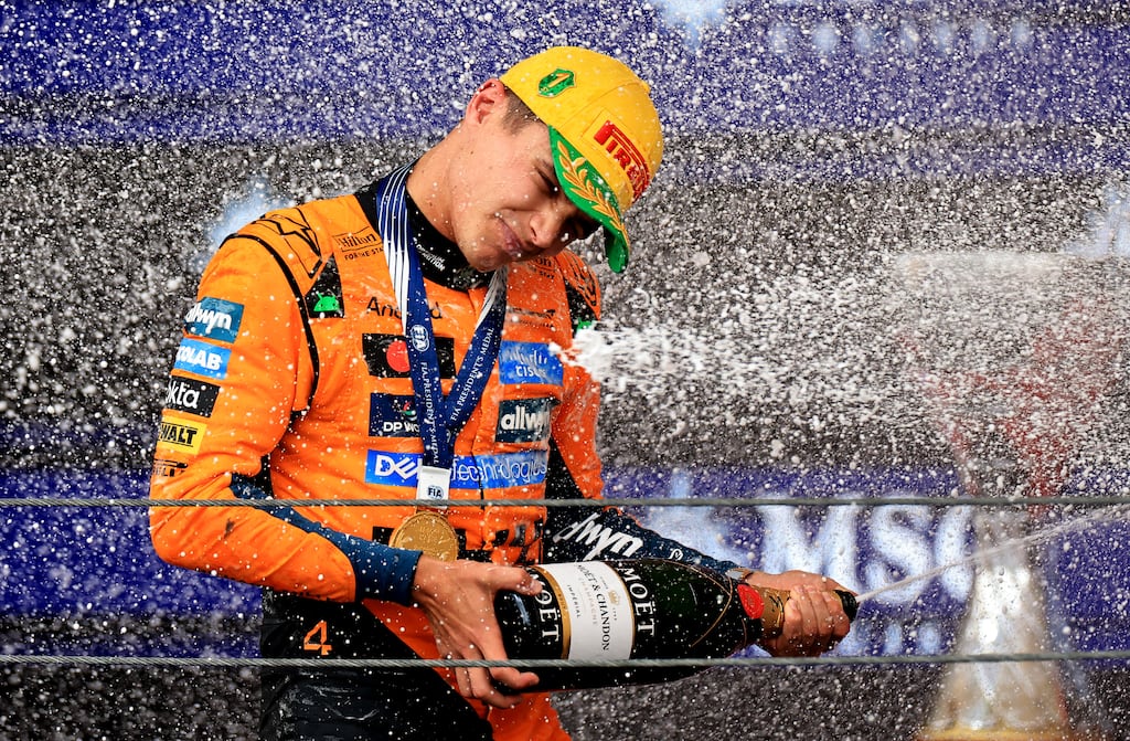 Race winner Lando Norris of McLaren sprays the victory Champagne on the podium after the F1 Grand Prix of Brazil. Photograph: Buda Mendes/Getty Images